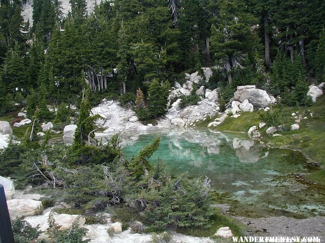 A turquoise green shallow cool water pool above the Bumpass Hell hydrothermal area