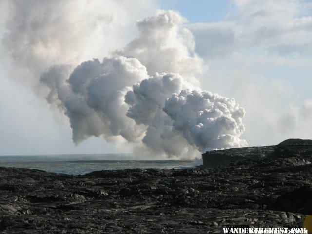 Steam from lava flowing into the ocean.