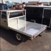 Custom low profile aluminum flatbed for Four Wheel Campers Hawk model on Chevy 2500HD